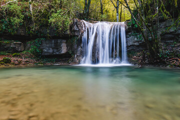 Fototapeta na wymiar beautiful little waterfall in the forest
