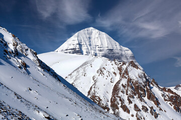 Sacred mount Kailash (elevation 6638 m) on blue sky background in Tibet, China. It is considered a sacred place in four religions: Bon, Buddhism, Hinduism and Jainism