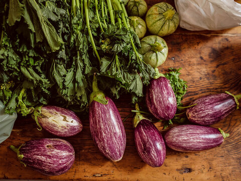 Fresh vegetables on the wooden table, eggplans , Cime di rapa