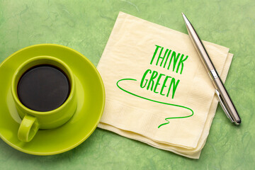 think green - handwriting on a napkin with a cup of coffee, environmental concept
