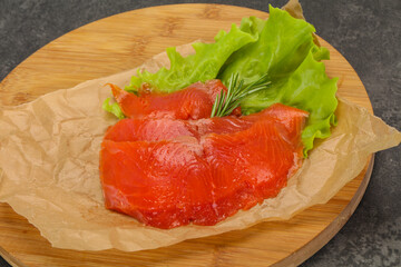 Sliced salmon fillet served rosemary