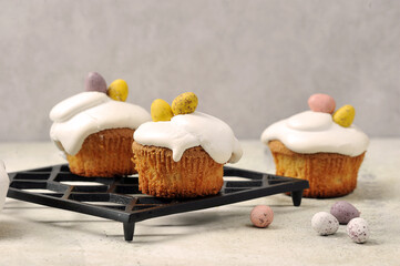 Easter muffins and chocolates in the shape of eggs.  Light background.  Close-up.