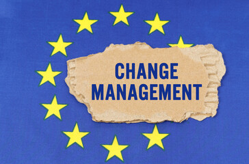 There is a cardboard box on the EU flag that says- CHANGE MANAGEMENT