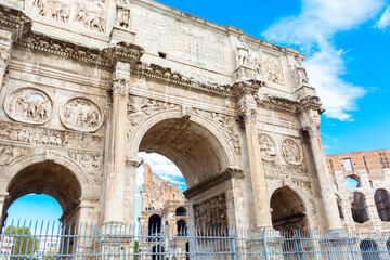 arch of constantine and colosseum in the background in Rome, Italy on a Sunny day with blue sky.