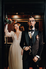 Stylish wedding couple in the interior. Glamorous bride and groom