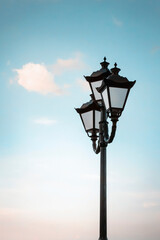Fototapeta na wymiar Beautiful old lantern on a background of blue sky. Vertical photography.