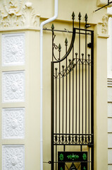 A fragment of a beautiful wrought-iron gate. Vertical photography.