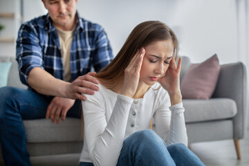 Middle-aged woman feeling stressed, facing health issues, having problem, her husband supporting...