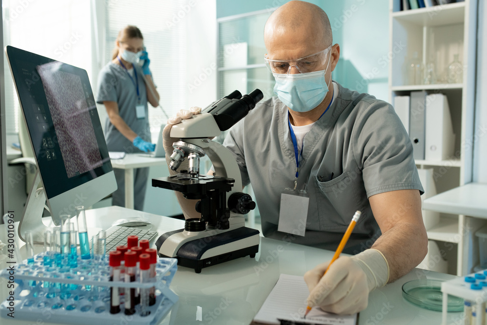 Poster Lab worker making notes about samples