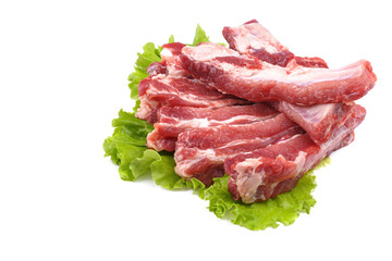Sliced pork ribs on a lettuce leaf are isolated on a white background.Preparation of meat dishes.