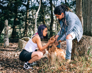 Couple in love sharing the love of their pet in the middle of nature