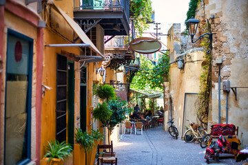 A cozy little street of a tourist town with cafes and restaurants.