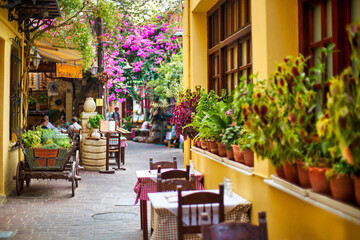A cozy little street of a tourist town with cafes and restaurants.