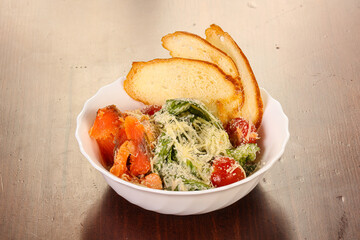 Caesar salad with salmon fish