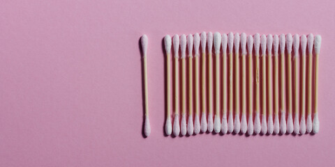 Pink bamboo cotton swabs in row. Flat lay pattern. Eco-friendly buds.