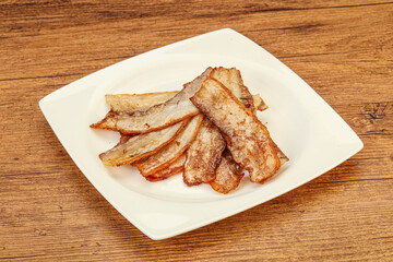 Roasted juicy bacon in the plate