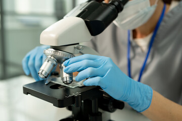 Adjusting microscope slide in laboratory