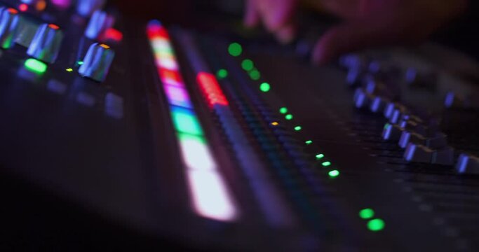 Colored lights of the controls and buttons of the sound panel during the concert.