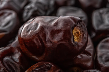 Dried dates close-up. Macro shot of delicious dried date fruits. Tasty vegetarian, dieting and high-calorie healthy food ingredient. Ready to eat sweet fruits and berries. Organic Iranian dates.