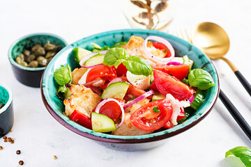 Traditional italian tomato salad panzanella with mozzarella, capers, red onion and croutons. Summer salad. Tuscan salad.