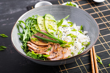 Homemade baked sliced beef and rice bowl with salad. Diet menu.