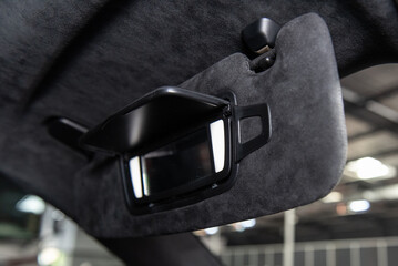 Vanity lights shine as sun shade mirror flip open from behind the visor.