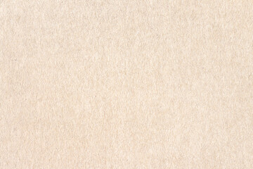 Fototapeta na wymiar A sheet of light brown paper. Rough smooth texture.