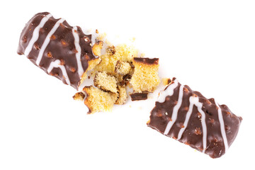 Broken chocolate chip cookies. Pieces and crumbs of a chocolate stick or bar are isolated on a white background . Top View.