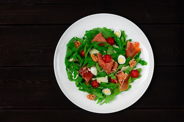 Salad, arugula leaves, with Parma prosciutto, cherry, quail eggs, healthy food, top view, horizontal, no people,