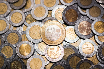 Mexico City, Mexico »; April 24 2021: twenty Mexican pesos in currency, with more coins around. 
