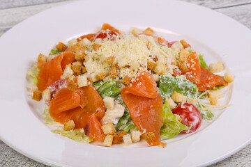 Caesar salad with salmon and parmesan