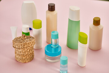 Skin care products, closeup view, pink background