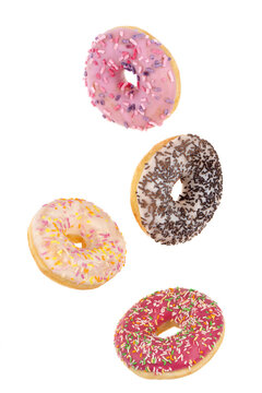 Donuts close-up on a white background. Flying round donuts isolated on white background.