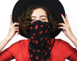 Virus protection. Protective mask. Beautiful girl in bright red clothes. Black hat. Red-black mask headscarf that protects against viruses