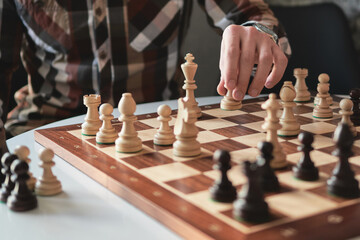 game of chess a game of chess the player making a move by a chess fish. Chess board from wood