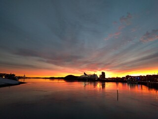 sunset in the harbor with view over the sea