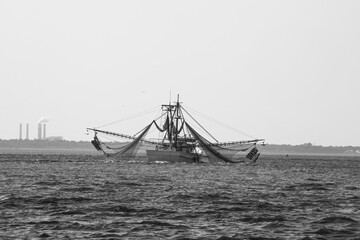 Shrimp boat with nets in black and white