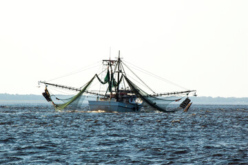 Shrimp boat with nets coming home