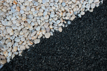 The white and black pebbles split each side in a yin and yang pattern.