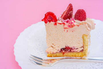 Slice of Cake with strawberries and vanilla cream for party. Delicious biscuit cake with red berries on cake stand