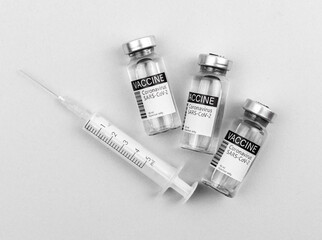 Vaccination concept background, coronavirus vaccine with syringe on the bright white grey...
