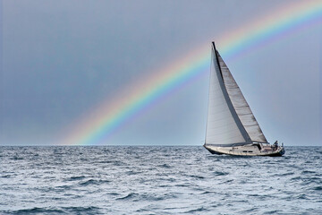 Sailboat sailing on Lake Michigan with rainbow in sky