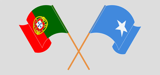 Crossed and waving flags of Portugal and Somalia