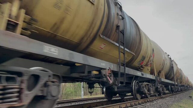 Long freight train rolling by a rural area on its way . High quality 4k footage
