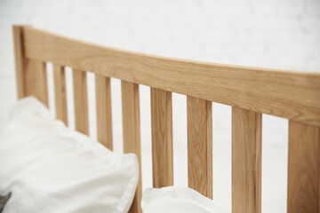 Fototapeta na wymiar Light ash wood bed, details