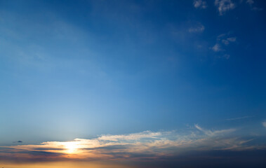 beautiful sunset sky, bright sunlight and silhouette of clouds as a background