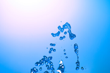 drops of the fountain in the setting sun