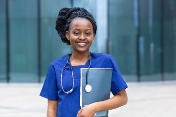 smart black girl medical student, happy young african american woman doctor, nurse in blue uniform, stethoscope, smiling afro female at university, college, hospital, clinic. copy space