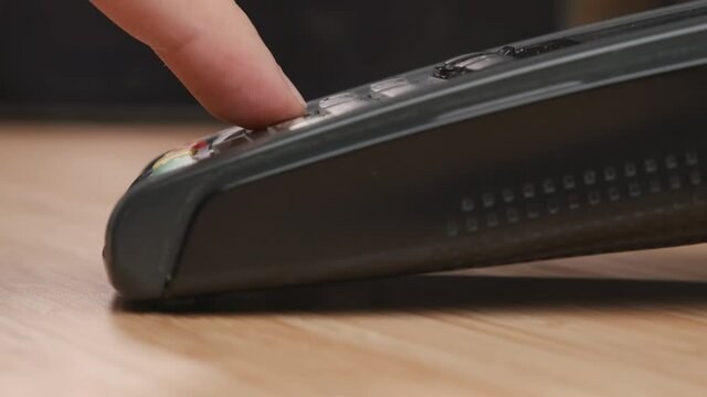 Close up man hand swiping credit card and enters a pin code using POS terminal for payment. 