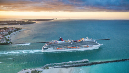 Cruise ship departs from Miami Port at sunset, aerial view